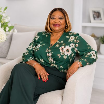 Charmaine A. Hickey, REALTOR® with Lang Realty, smiling in a green floral blouse